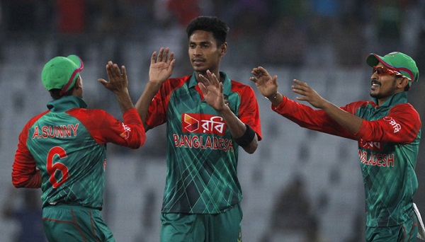 Bangladeshs Mustafizur Rahman, center, celebrates with teammates the dismissal of Zimbabwes Chamu Chibhabha, foreground, during the third one-day international cricket match between the two teams in Dhaka, Bangladesh, Wednesday, Nov. 11, 2015. (AP Photo/A.M. Ahad)