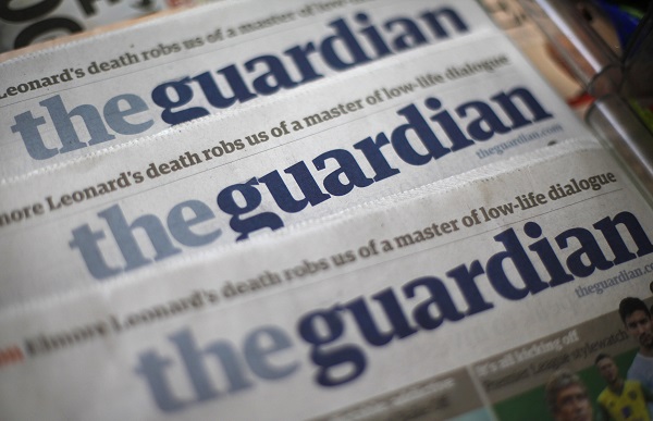 Copies of the Guardian newspaper are displayed at a news agent in London August 21, 2013. British Prime Minister David Cameron ordered his top civil servant to try to stop revelations flowing from the Guardian newspaper about U.S. and British surveillance programmes, two sources with direct knowledge of the matter said. REUTERS/Suzanne Plunkett (BRITAIN - Tags: MEDIA POLITICS) - RTX12S8X