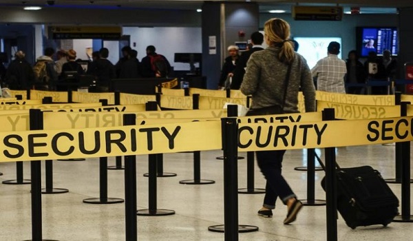 FILE PHOTO - Passengers make their way in a security checkpoint at the International JFK airport in New York October 11, 2014. REUTERS/Eduardo Munoz