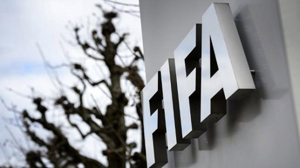 FIFA logo on a building wall with a tree in the background. Channel i News - চ্যানেল আই নিউজ