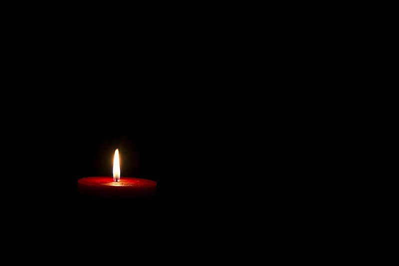 একটি মোমবাতি জ্বলছে, অন্ধকারে আলোর ছোঁয়া. Channel i News - চ্যানেল আই নিউজ