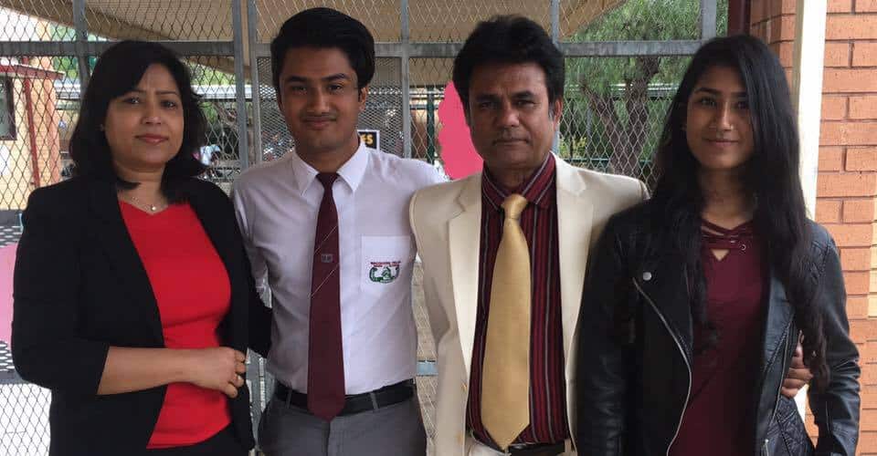 চারজন মানুষ একসঙ্গে দাঁড়িয়ে, পেছনে গেট ও ব্রিক ওয়াল দেখা যাচ্ছে. Channel i News - চ্যানেল আই নিউজ