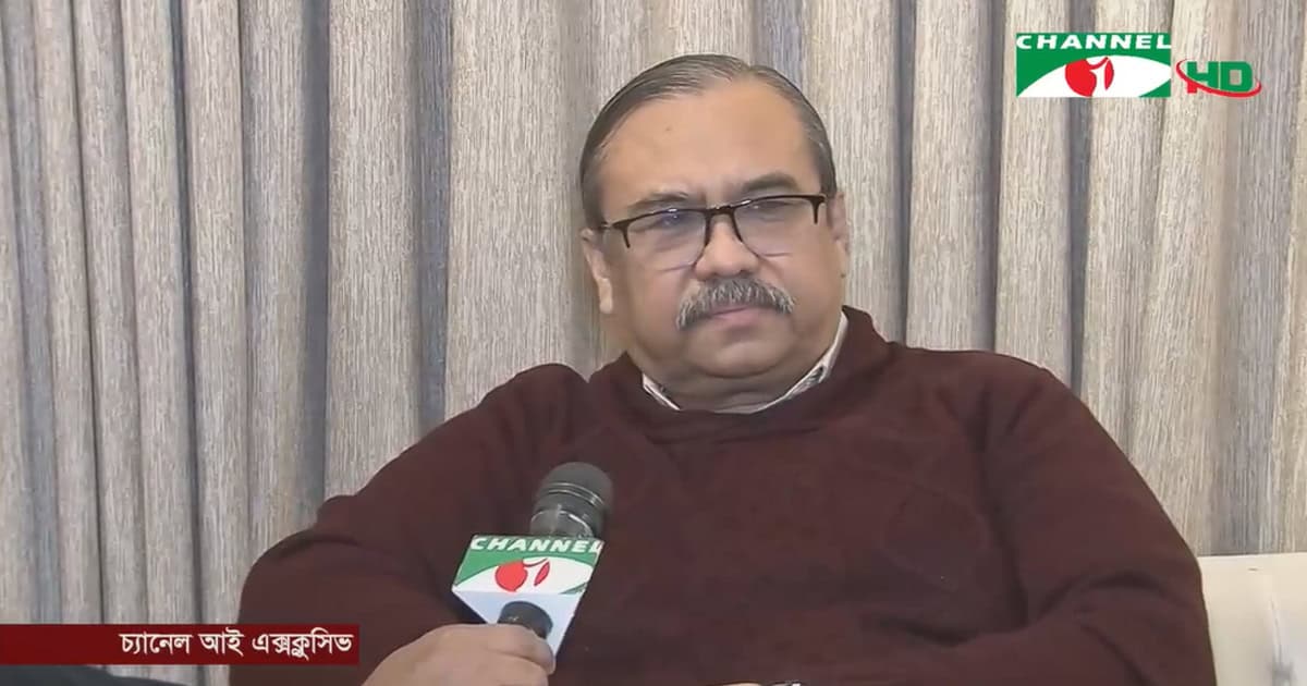 Bangladeshi man speaking into a microphone during a Channel i interview. Channel i News - চ্যানেল আই নিউজ