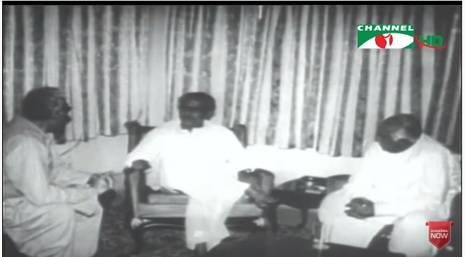 তিনজন ব্যক্তি বসে আলোচনা করছেন, পটভূমিতে পর্দা।. Channel i News - চ্যানেল আই নিউজ