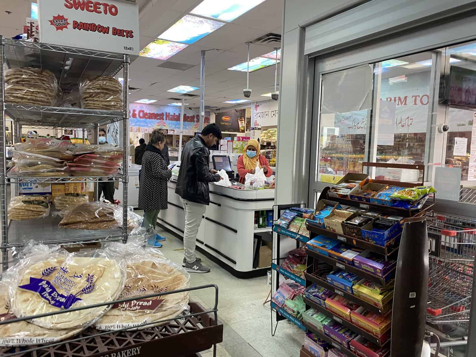 Canadian grocery store with customers shopping and checkout counter. Channel i News - চ্যানেল আই নিউজ