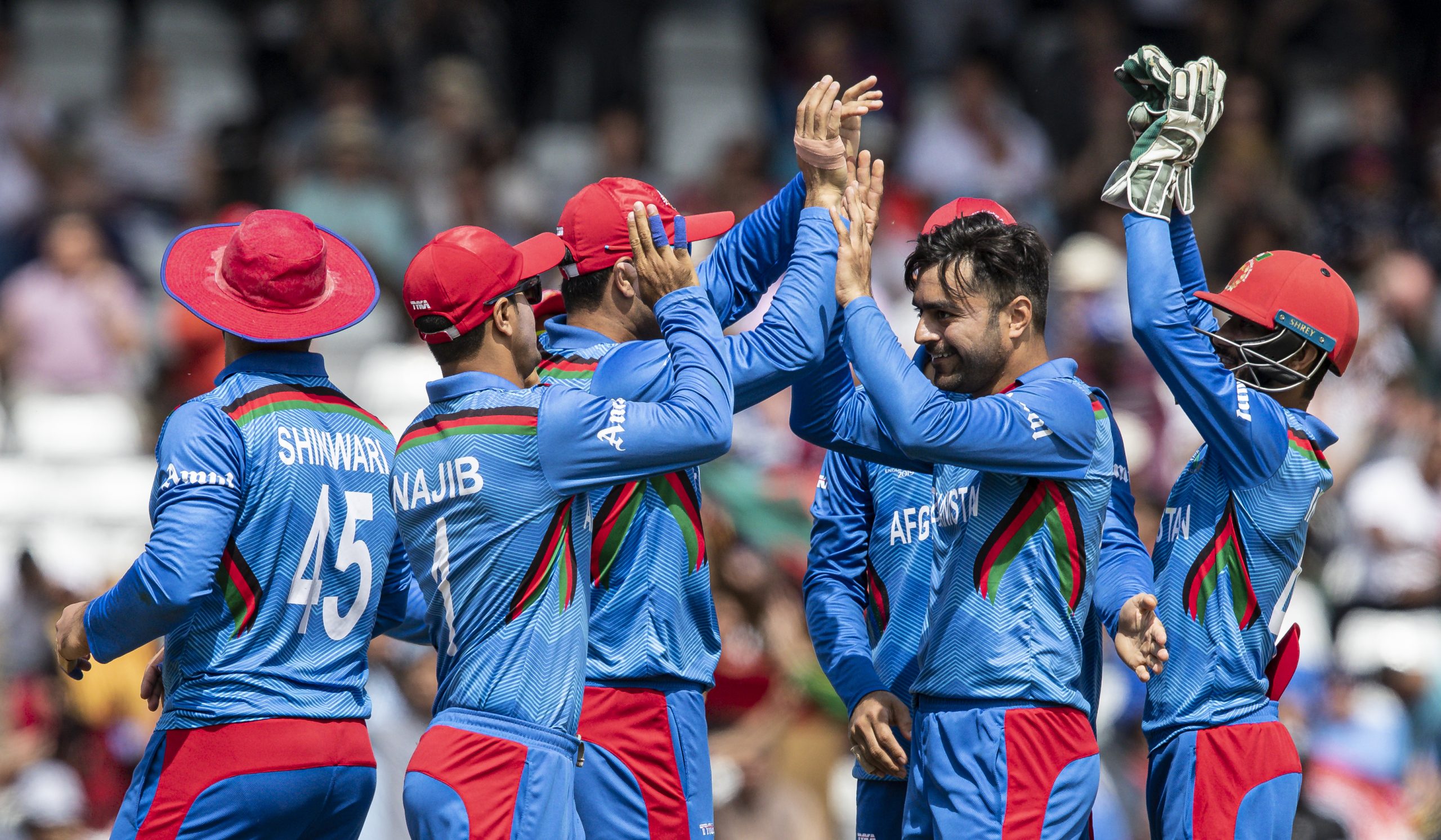 LEEDS, ENGLAND - JULY 04: Rashid Khan of Afghanistan (2nd right) celebrates with his team mates after taking the wicket of Evin Lewis of West Indies (not shown) during the Group Stage match of the ICC Cricket World Cup 2019 between Afghanistan and West Indies at Headingley on July 04, 2019 in Leeds, England. (Photo by Andy Kearns/Getty Images)