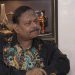 বাংলাদেশি ব্যক্তি বসে আছেন, পটভূমিতে আসবাবপত্র ও সজ্জা দেখা যাচ্ছে. Channel i News - চ্যানেল আই নিউজ