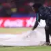 বৃষ্টির কারণে মাঠে খেলা বন্ধ, মাঠের পিচ ঢেকে দিচ্ছেন একজন কর্মকর্তা. Channel i News - চ্যানেল আই নিউজ