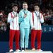 তিনজন জিমন্যাস্ট স্বর্ণপদক নিয়ে প podium এ দাঁড়িয়ে. Channel i News - চ্যানেল আই নিউজ