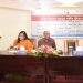 আলোচনাসভায় অংশগ্রহণকারী ও বক্তারা বসে আছেন, একটি মঞ্চে আলোচনা চলছে।. Channel i News - চ্যানেল আই নিউজ