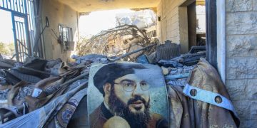 TOPSHOT - A portrait of Hezbollah chief Hassan Nasrallah sits amid destruction in a area targeted overnight by Israeli airstrikes in Saksakiyeh on September 26, 2024. Israel flatly rejected on September 26 a push led by key backer the United States for a 21-day ceasefire in Lebanon, as it vowed to keep fighting Hezbollah militants "until victory". (Photo by Mahmoud ZAYYAT / AFP) (Photo by MAHMOUD ZAYYAT/AFP via Getty Images)