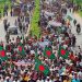 বাংলাদেশের জনগণের বিশাল গণজমায়েত, পতাকা বহন করছে মানুষ. Channel i News - চ্যানেল আই নিউজ