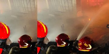 ফায়ারফাইটাররা আগুন নিয়ন্ত্রণে আনতে কাজ করছে, ধোঁয়া ও আগুনের লাল আলো দৃশ্যমান. Channel i News - চ্যানেল আই নিউজ