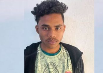 Young man with curly hair and serious expression against plain background. Channel i News - চ্যানেল আই নিউজ