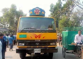 Bangladesh road accident involving truck and motorcycle, many bystanders present. Channel i News - চ্যানেল আই নিউজ