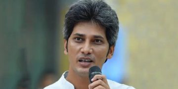 জোনায়েদ সাকি speaking at a public event with a microphone in hand. Channel i News - চ্যানেল আই নিউজ