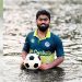 জলমগ্ন অবস্থায় ফুটবল হাতে থাকা শিক্ষার্থী সাজিদ আব্দুল্লাহ. Channel i News - চ্যানেল আই নিউজ