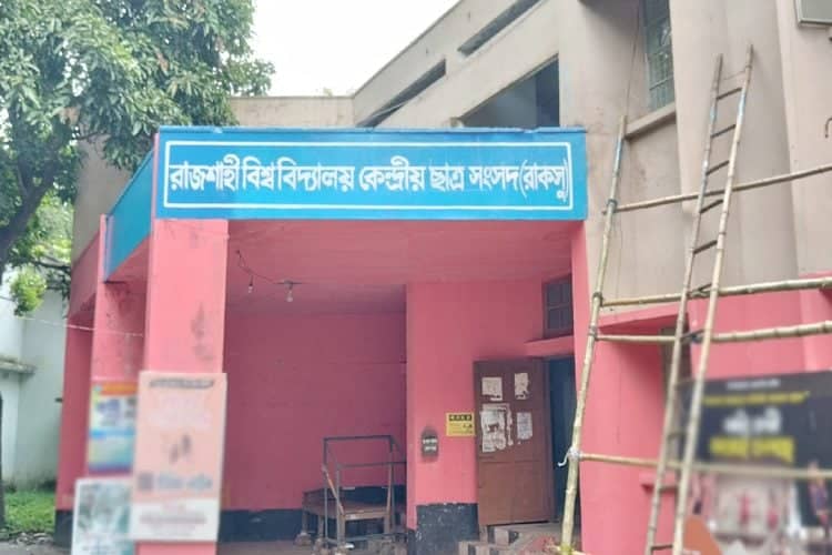 রাবির কেন্দ্রীয় ভবনের প্রবেশদ্বার, বাংলা ভাষায় লেখা সাইনবোর্ডসহ. Channel i News - চ্যানেল আই নিউজ