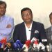 সংবাদ সম্মেলনে তিনজন বক্তা, microphones ও ক্যামেরার সামনে. Channel i News - চ্যানেল আই নিউজ