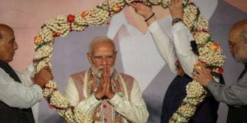 India's Home Minister Amit Shah and India's Defence Minister Rajnath Singh present a garland to Prime Minister Narendra Modi, as Bharatiya Janata Party (BJP) supporters celebrate the Bihar state assembly election results, at the party headquarters in New Delhi, India, November 14, 2025. REUTERS/Adnan Abidi