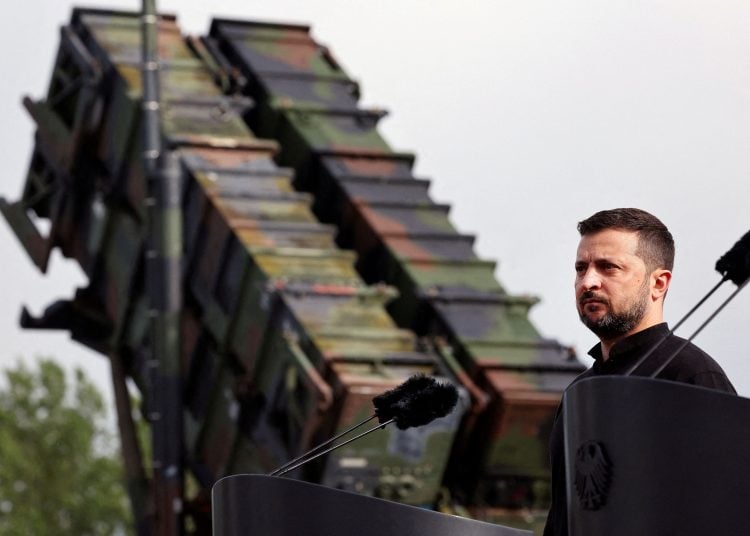FILE PHOTO: Ukrainian President Volodymyr Zelenskiy looks on during a visit to a military training area to find out about the training of Ukrainian soldiers on the “Patriot” anti-aircraft missile system, at an undisclosed location, in Germany, June 11, 2024.   Jens Buttner/Pool via REUTERS/File Photo