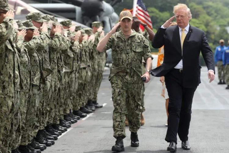 ছবি: প্রেসিডেন্সির প্রথম মেয়াদে টোকিওর দক্ষিণে ইয়োকোসুকায় 'ইউএসএস ওয়াস্প' যুদ্ধজাহাজে সেনাদের স্যালুট করছেন ডোনাল্ড ট্রাম্প।